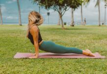 A woman practices yoga in a park, enjoying the outdoors. Perfect for wellness and fitness themes.