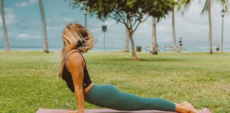 A woman practices yoga in a park, enjoying the outdoors. Perfect for wellness and fitness themes.
