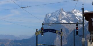 Scenic view of train station with Swiss Alps in the background. Perfect for travel enthusiasts.