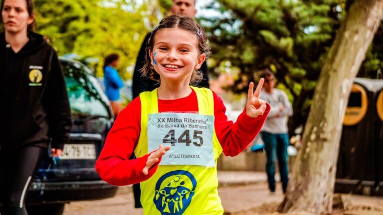 Young girl participating in a vibrant marathon event, showing enthusiasm and energy.
