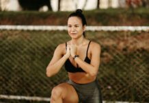 Woman doing squats in a park, embracing fitness and healthy lifestyle.