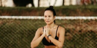 Woman doing squats in a park, embracing fitness and healthy lifestyle.