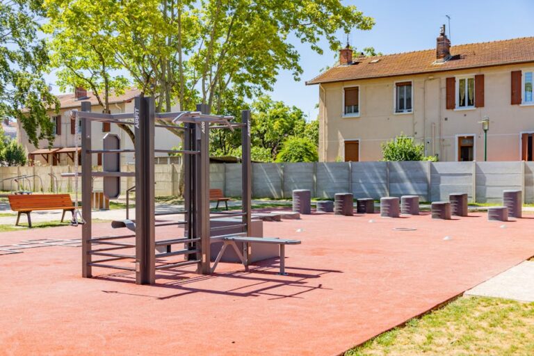 Public outdoor gym with exercise equipment in a sunny park in Saint-Priest, France.